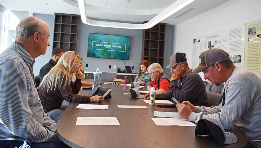 Soil & Water District Board members sitting around a table at a board meeting