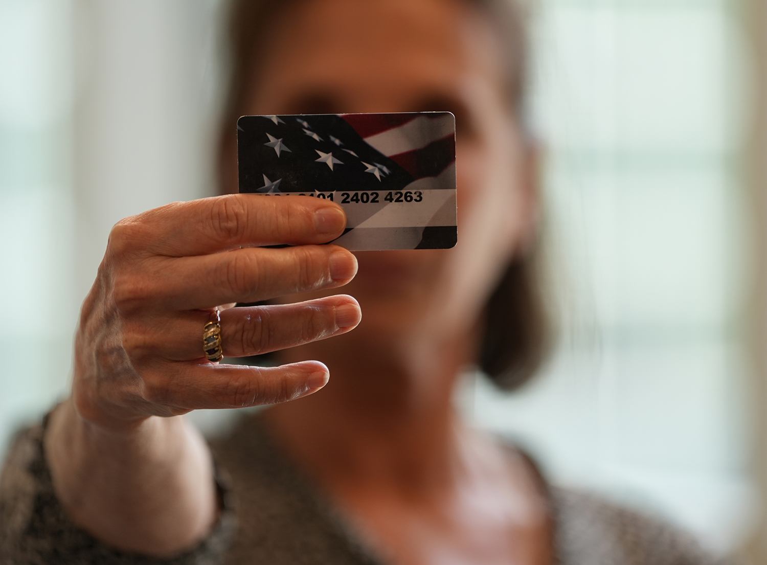 woman holding up an NC EBT card