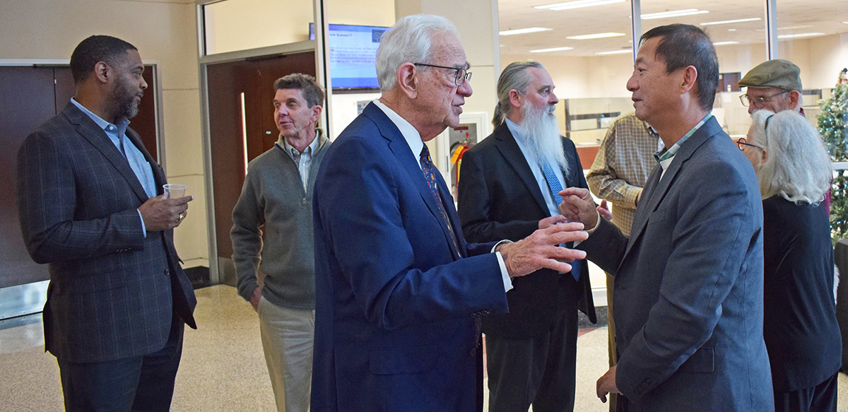County Commissioner Don Martin greets board members at reception